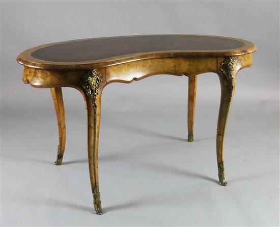 A Victorian crossbanded walnut kidney shaped writing table, W.4ft 3in. D.2ft 3in. H.2ft 6in.